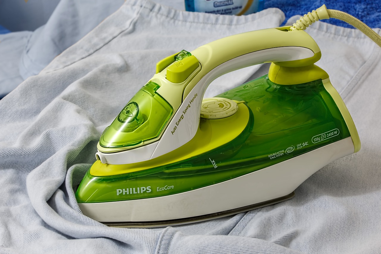 Green Household Iron with Unironed pants